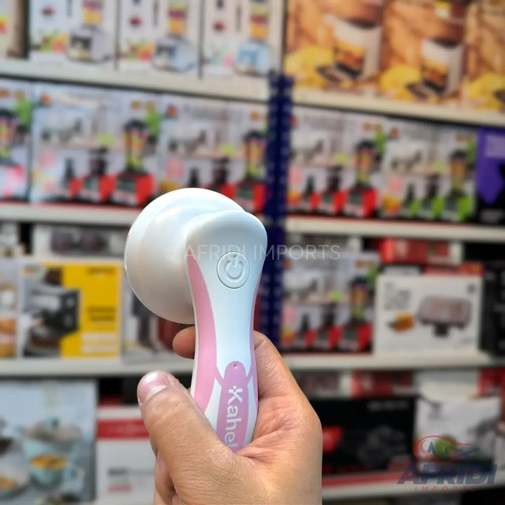 White and pink handheld lint remover with a power button.