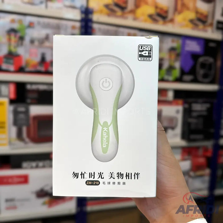 White and green electric lint remover with a USB charging port.