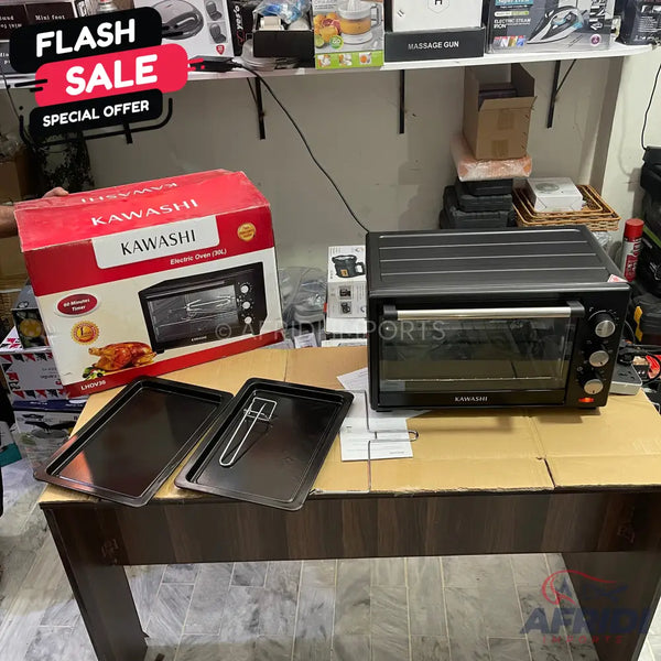 A black electric toaster oven with a clear glass door, three control knobs, and an accompanying box showing a roasted chicken, along with two baking trays and a rack.