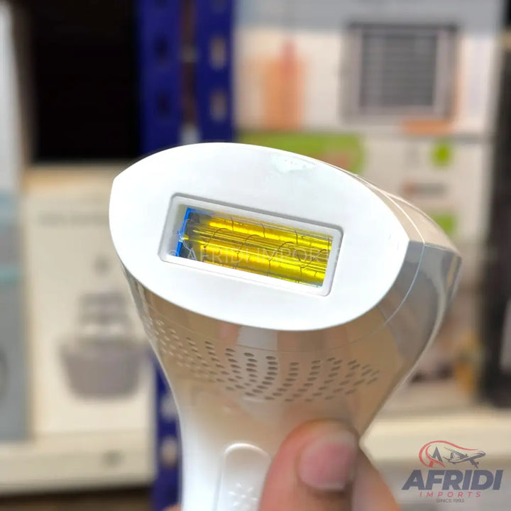 A handheld IPL hair removal device with a yellow light window.