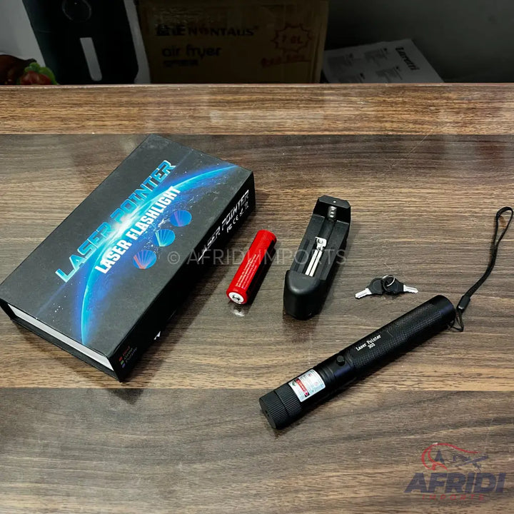 A black laser pointer with a wrist strap, accompanied by a battery, charger, and two keys.