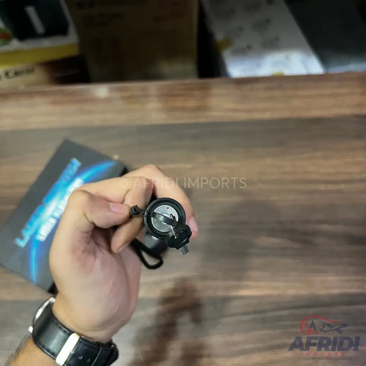 Black handheld laser pointer with a silver battery compartment.