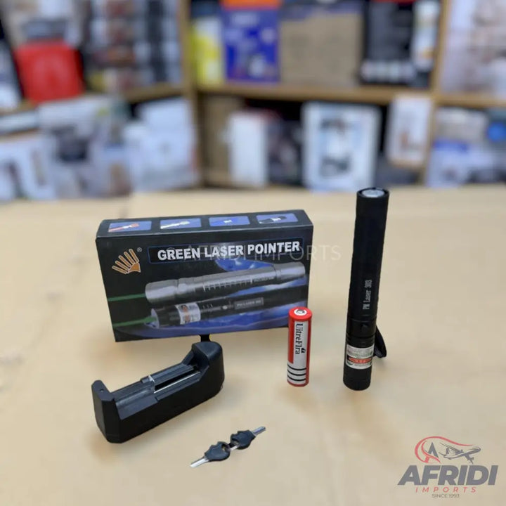Green laser pointer kit with charger, battery, and safety keys.