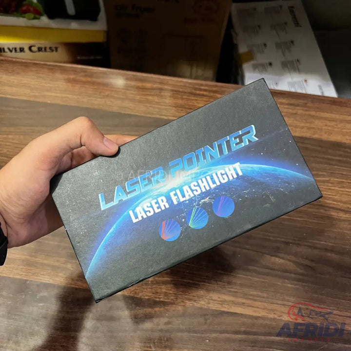 A black box for a laser pointer and flashlight with a blue cosmic design.
