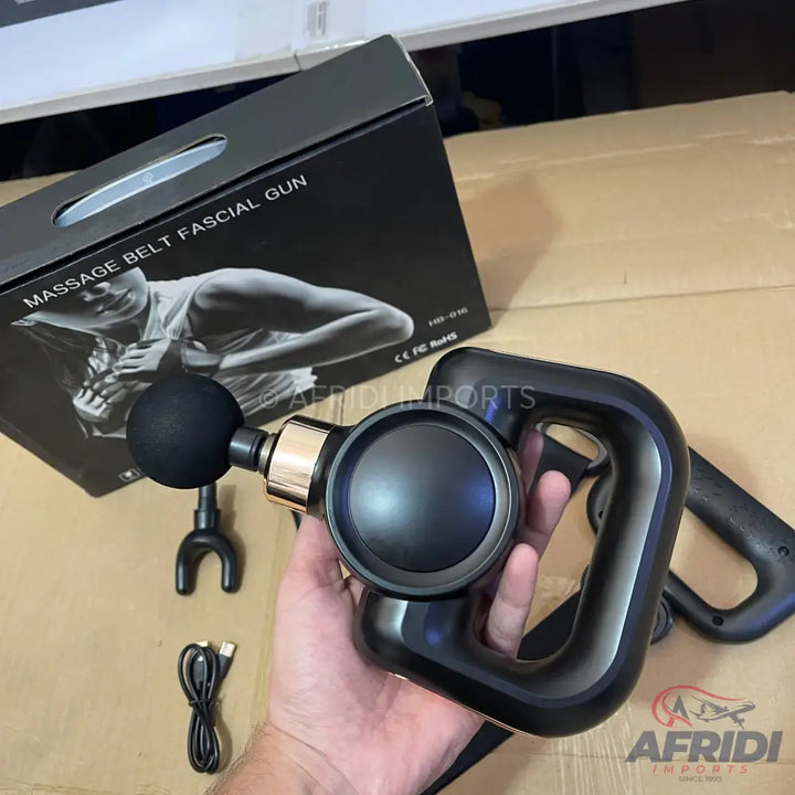 Black handheld percussive massage gun with multiple attachments.