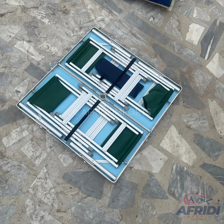 Portable folding table with attached chairs.