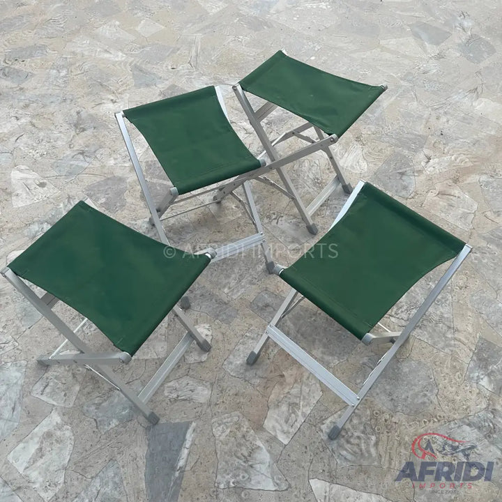 Four foldable green canvas camping stools.