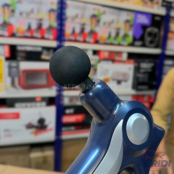 A dark blue massage gun with a spherical black attachment.