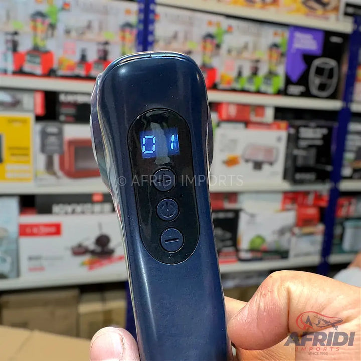 Dark blue handheld fabric shaver with a digital display showing ’01’’ and three control buttons.