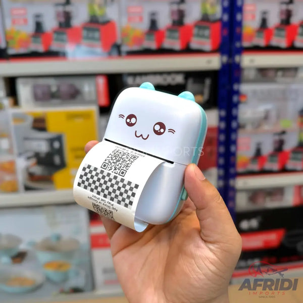 A white and blue portable thermal printer with a cute face design, printing a QR code on a paper roll.