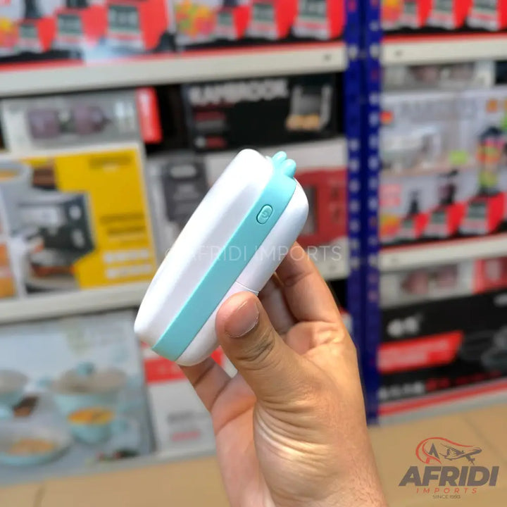 A white and light blue portable handheld device with a power button on the side.