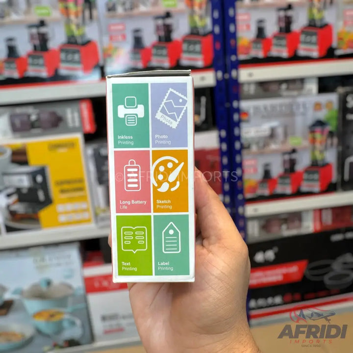 A handheld, rectangular product box displaying six features with icons and text: ’Inkless Printing,’ ’Photo Printing,’ ’Long Battery Life,’ ’Sketch Printing,’ ’Text Printing,’ and ’Label Printing.’