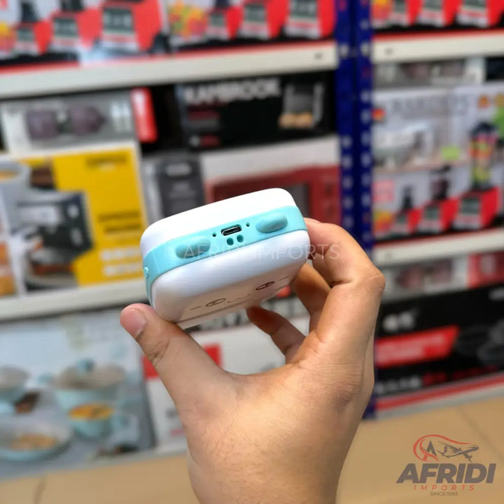 White and light blue portable device with a USB port and buttons.