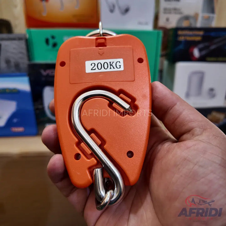 Orange digital hanging scale with a metal hook.