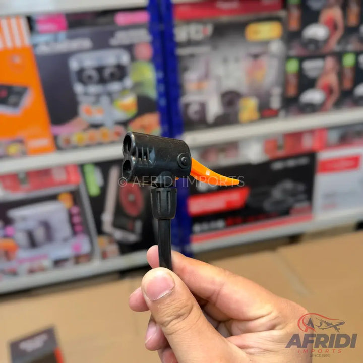 A black bicycle pump head with an orange lever.
