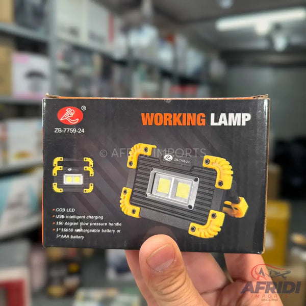 A black and yellow portable working lamp with two bright LED lights and a rotating handle, powered by USB intelligent charging or AAA batteries.