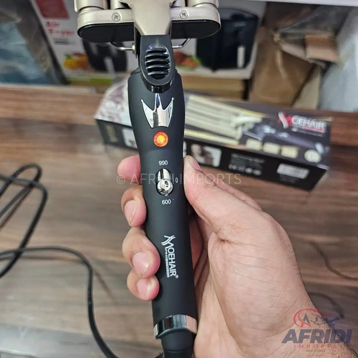 Black, triple-barrel hair waver with temperature control.