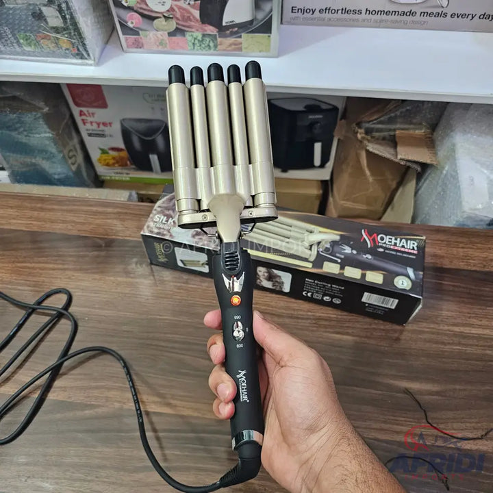 Black and gold five-barrel hair waver with temperature control.