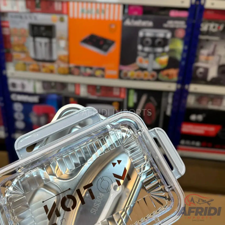 Shiny metal tongs with a clear plastic container.