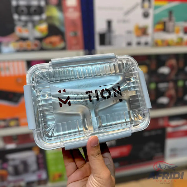 Stainless steel bento box with a clear lid and grey clasps.