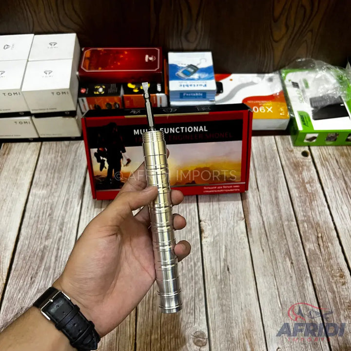 Silver-colored, multi-functional tool with a screwdriver bit.