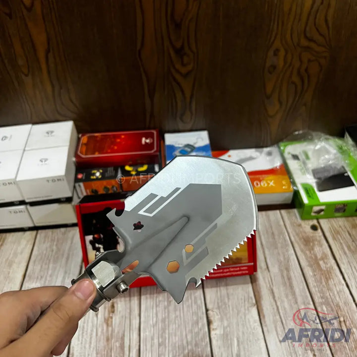 Compact, multi-functional, tactical shovel with a serrated edge.