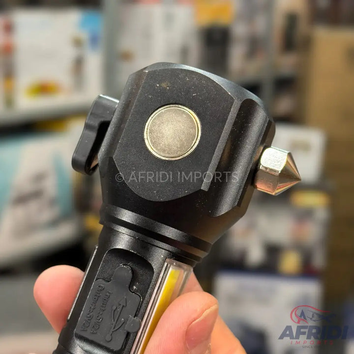 Black multi-functional flashlight with a magnetic base, side COB light, and a window breaker.
