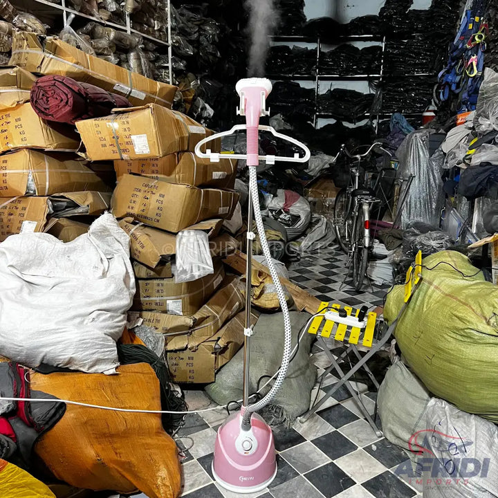 Pink garment steamer with a white hanger attachment.