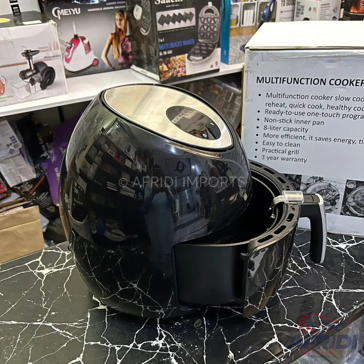 Black marble-patterned air fryer with an 8-liter capacity and non-stick inner pan.
