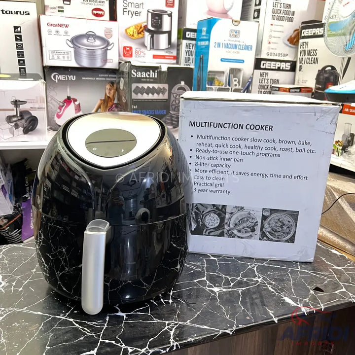 Black air fryer with a digital display and silver handle.