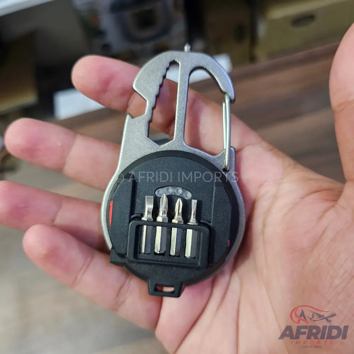 A multi-tool carabiner with an integrated screwdriver bit set.