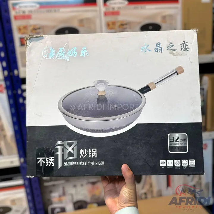 Stainless steel frying pan with a glass lid.