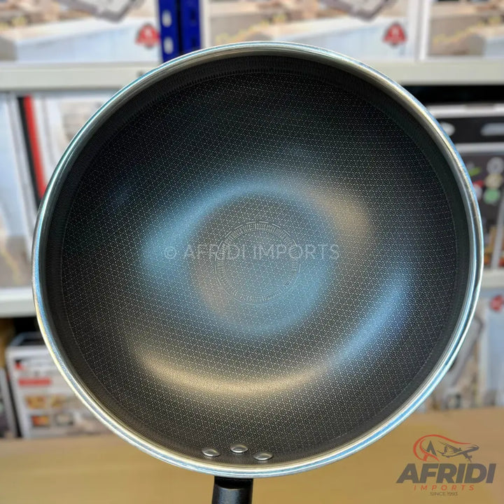 A black non-stick wok with a honeycomb pattern.