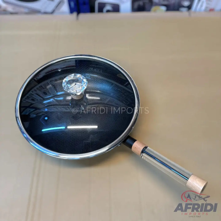 Black cooking pot with a glass lid and a clear, hollow handle.