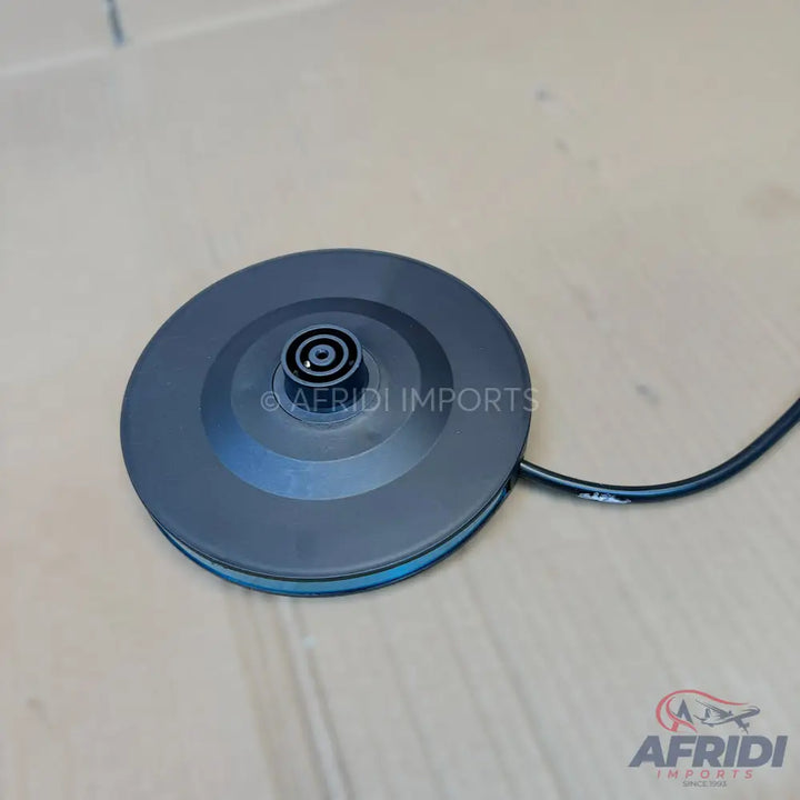 Black circular electric kettle base with a central power connector and an attached power cord.