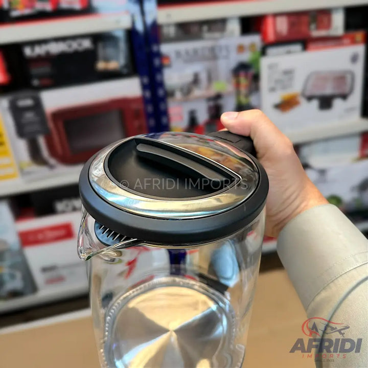 A clear glass electric kettle with a black and silver lid.