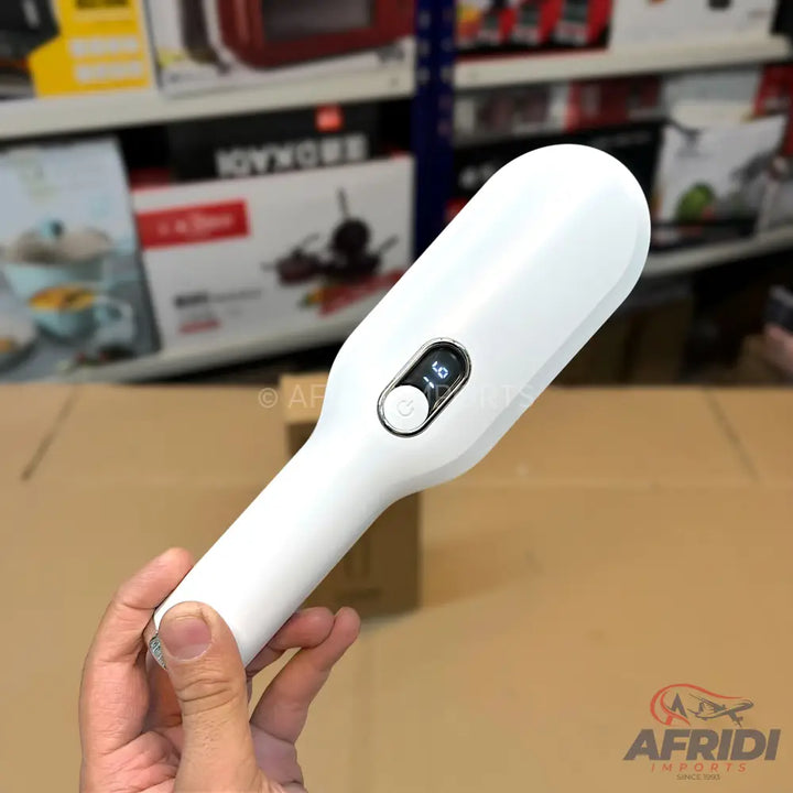 White handheld electric lint remover with digital display.