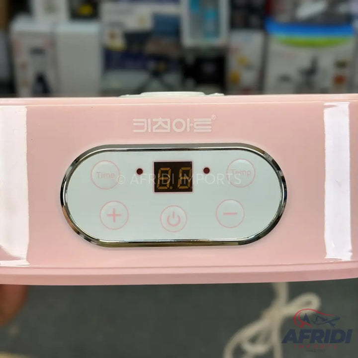 Pink portable electronic device with a digital display and control buttons.