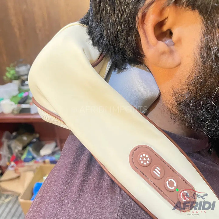 A beige U-shaped neck and shoulder massager with brown trim and control buttons.