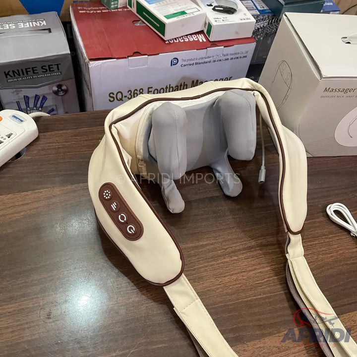 Cream-colored electric shoulder and neck massager with control buttons.