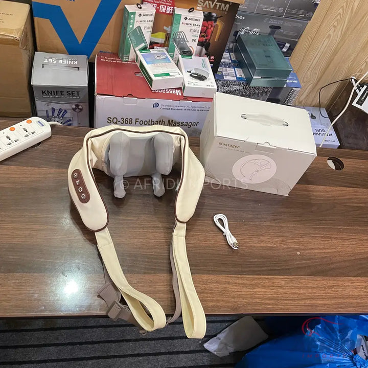 Beige electric shoulder and neck massager with control buttons.