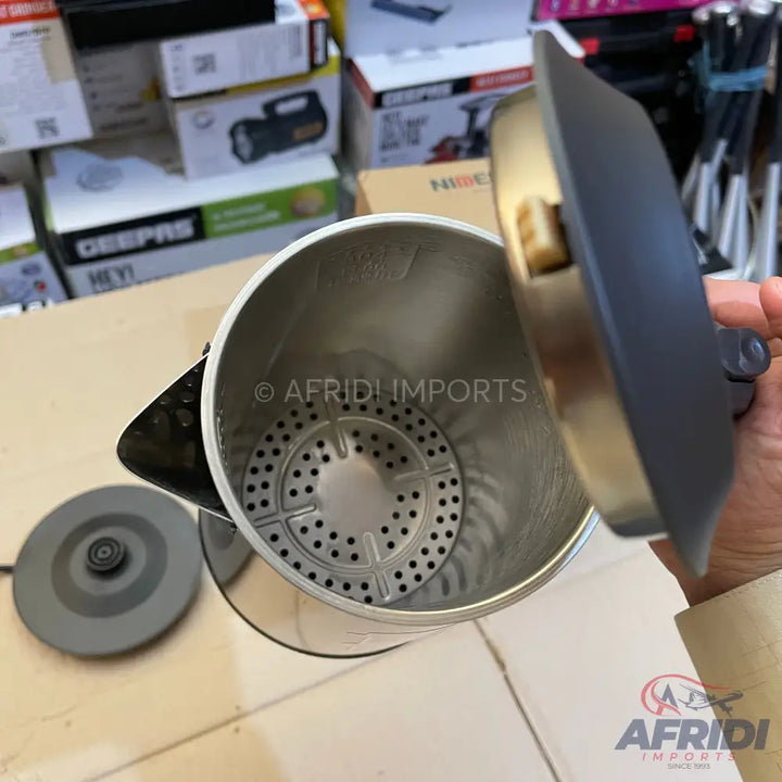 Stainless steel electric kettle with a perforated heating element.