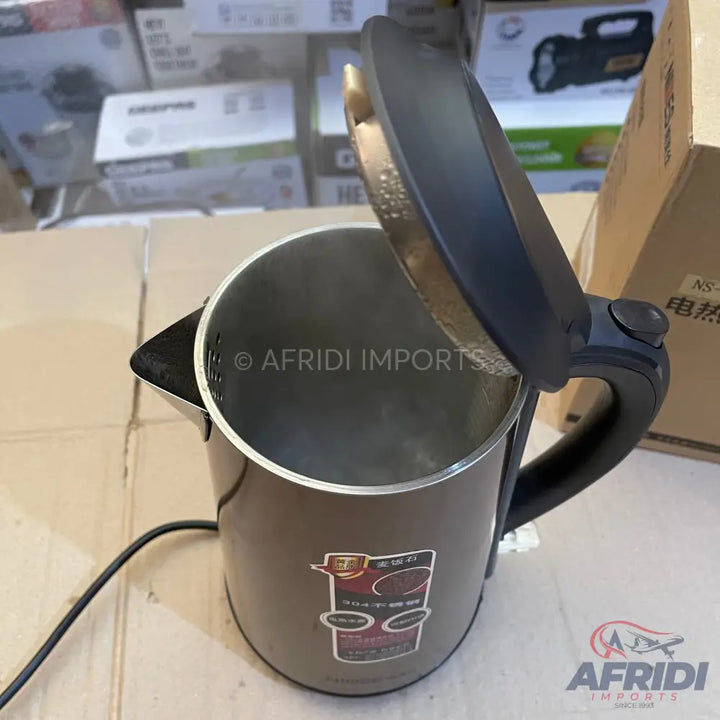 Dark grey electric kettle with an open lid.