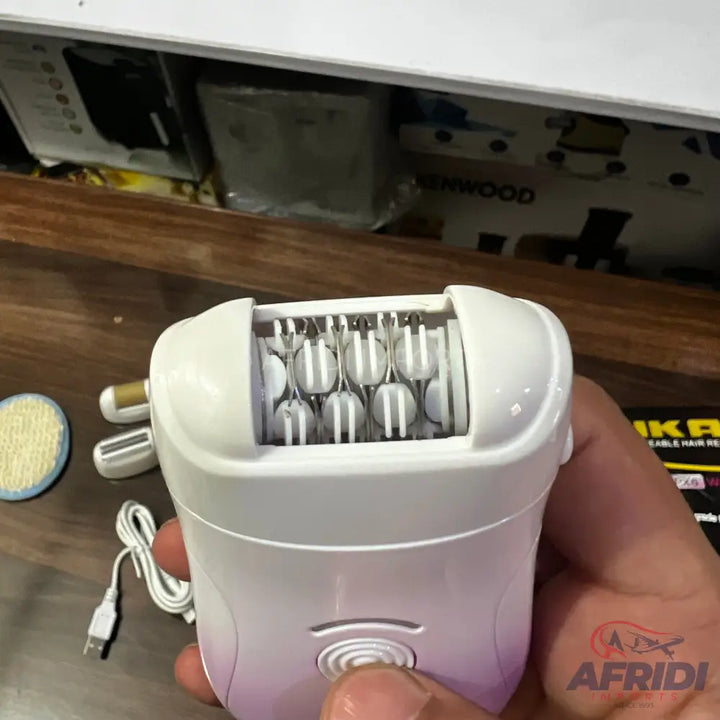 White handheld epilator with multiple tweezers and a circular power button.