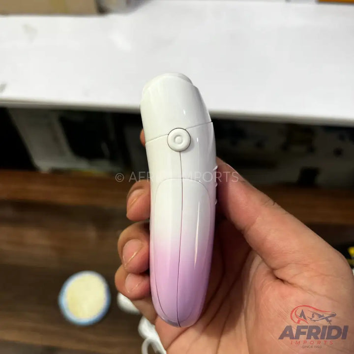 White and pink electric hair removal device with a circular button.