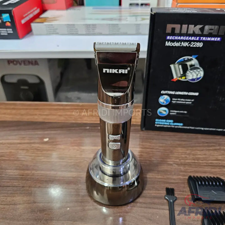 A dark brown and silver metallic rechargeable hair trimmer with a charging stand.