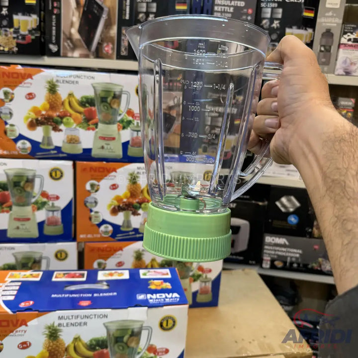 Clear plastic blender jar with a light green base and integrated blades.