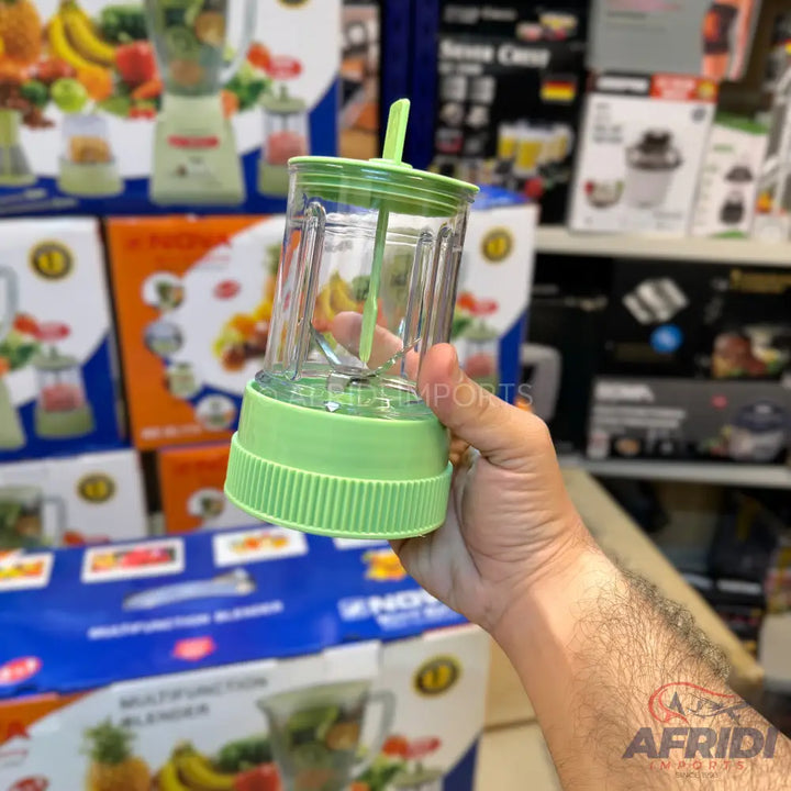 Light green and clear plastic portable blender with a straw.