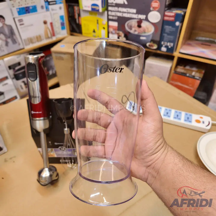 Clear plastic blending beaker with measurement markings.