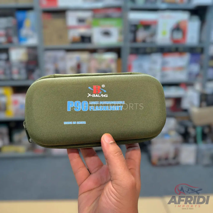 An olive green, zippered, hard-shell case for a P90 flashlight.